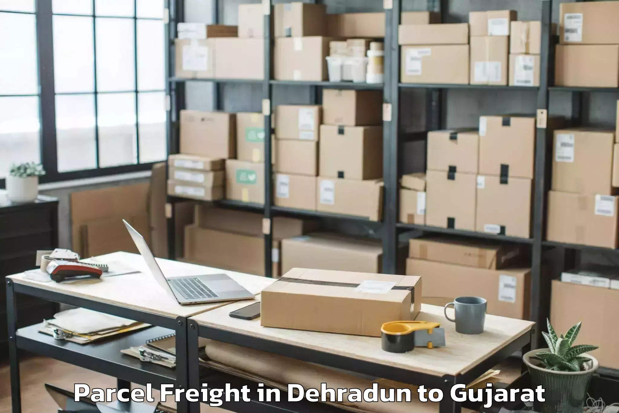 Professional Dehradun to Gujarat National Law Universit Parcel Freight